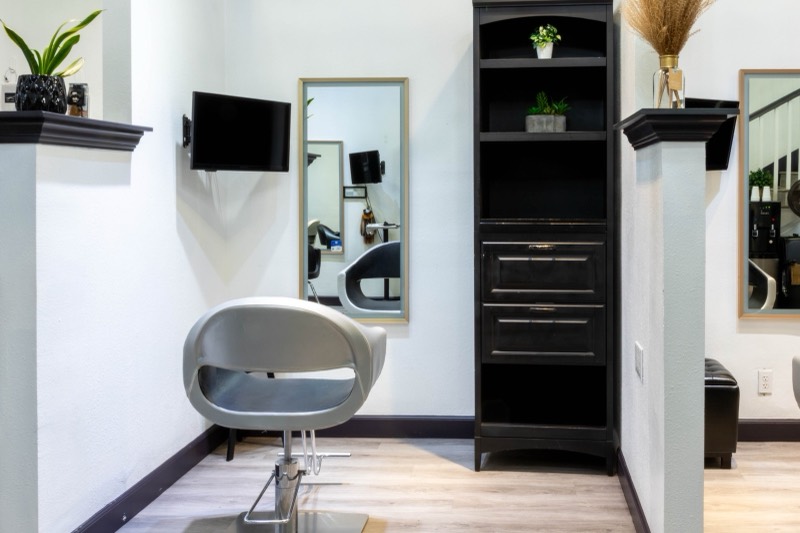 Booth 2 — stylist chair and wall mirror