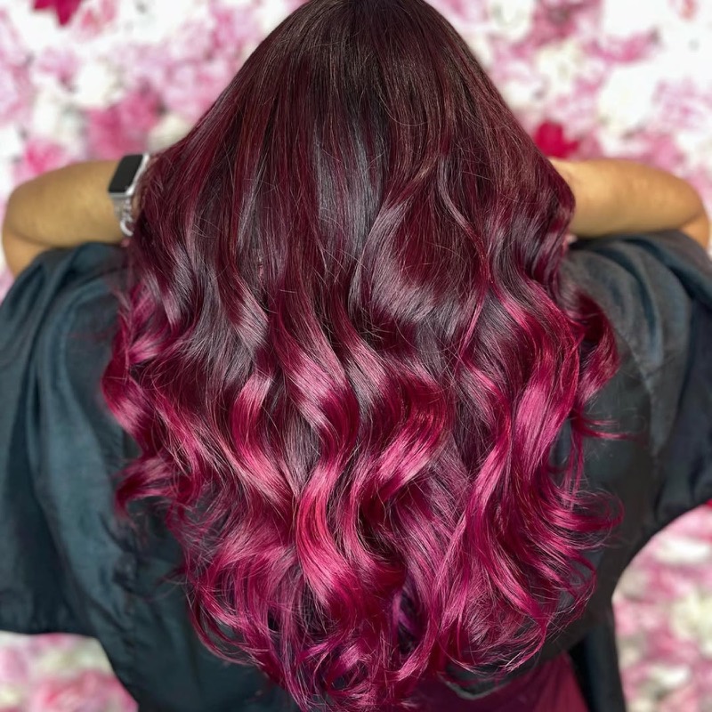 Dark-rooted magenta ombré waves, deep red melting into bright pink